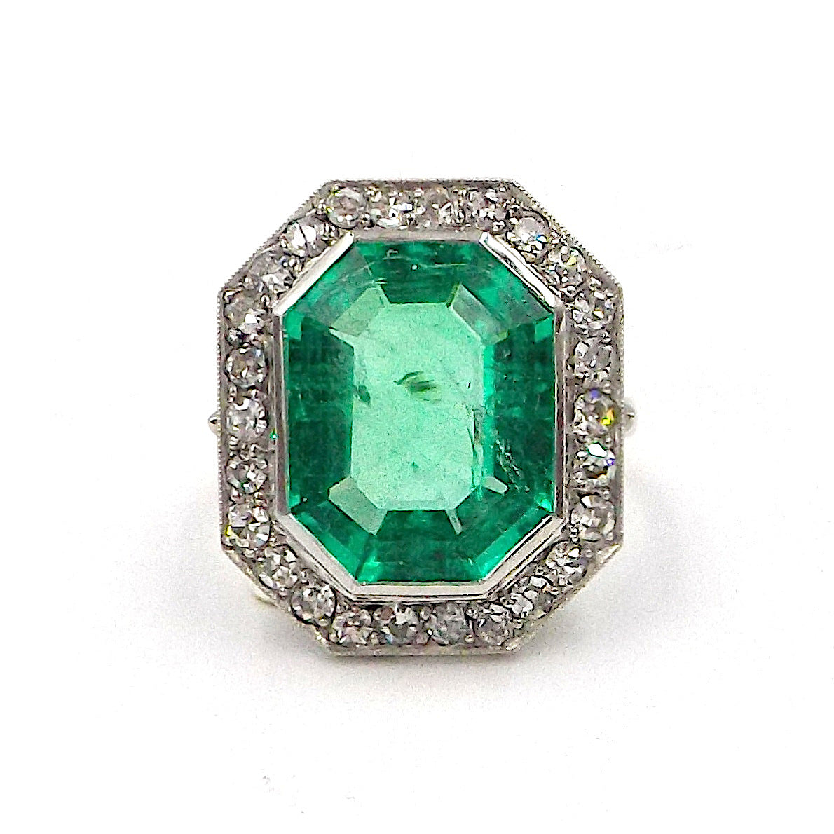 An emerald and diamond ring