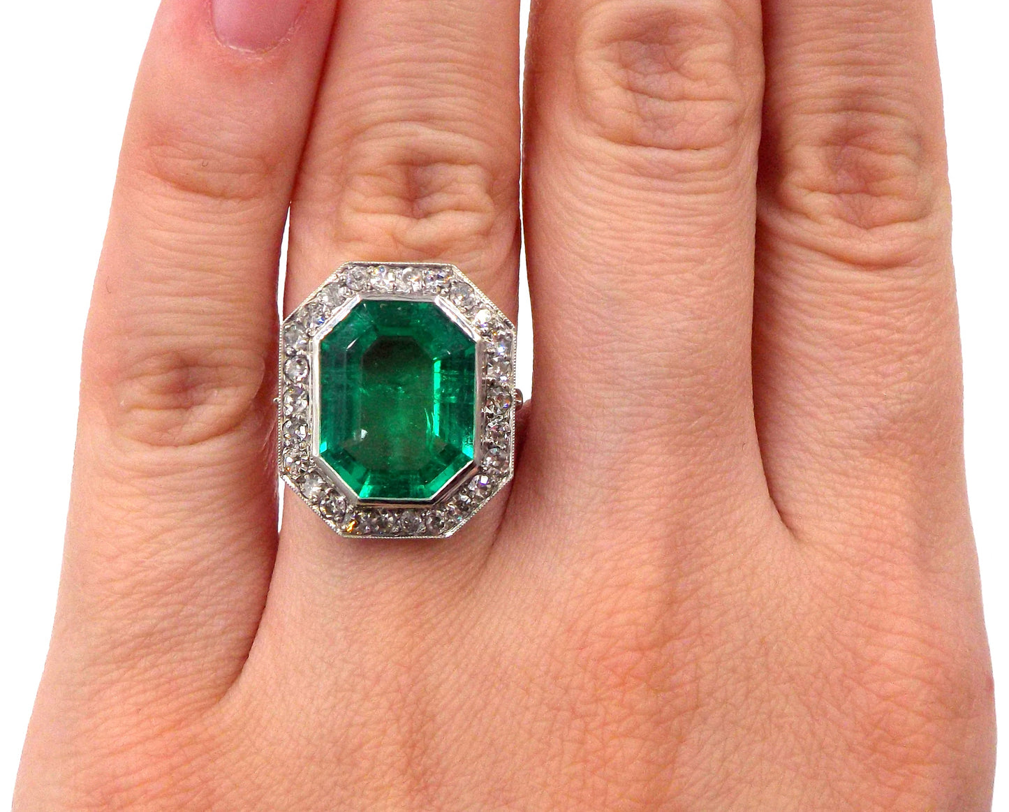 An emerald and diamond ring